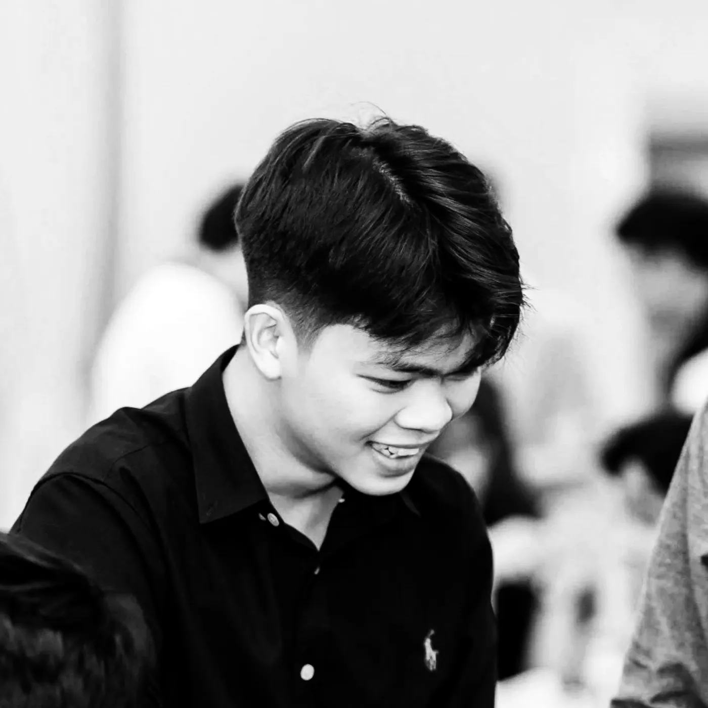 Vo Tu Trinh smiling and looking down